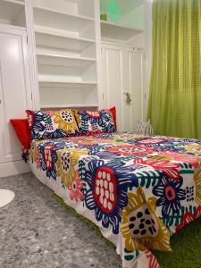 a bedroom with a bed with a colorful blanket at Villa Amaya in El Puerto de Santa María