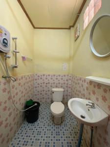 a bathroom with a toilet and a sink at Cam U View Bungalow in Nongkhiaw