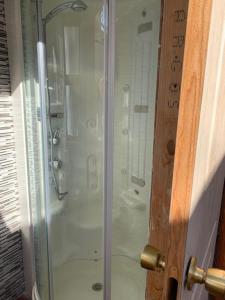 a shower with a glass door in a bathroom at Beautiful 3-Bed Town House with garden in Sax in Sax