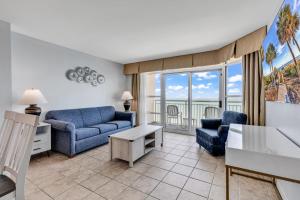 a living room with a couch and a table at Carolinian Resort 2032 in Myrtle Beach