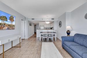 a living room with a couch and a dining room at Carolinian Resort 2032 in Myrtle Beach