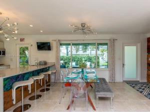 une cuisine et une salle à manger avec une table et des chaises en verre dans l'établissement Beautiful Bayfront House 3Bed 2Bth Home parking, à Dania Beach