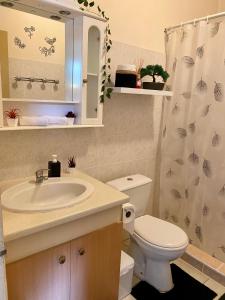 a bathroom with a sink and a toilet at Heiata Lodge Papeete in Papeete