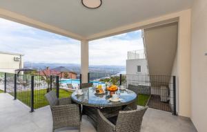 a patio with a glass table and chairs on a balcony at Nice Home In Bregi With House Sea View in Breza