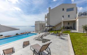 a villa with a swimming pool and a view of the ocean at Nice Home In Bregi With House Sea View in Breza