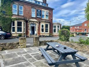 a picnic table sitting in front of a building at St Andrews house Hotel in Preston