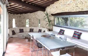 a living room with couches and a table and chairs at Stunning Home In Vaison-La-Romaine in Vaison-la-Romaine