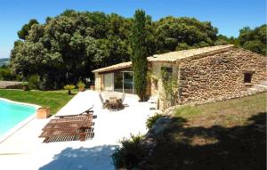 a stone house with a patio and a swimming pool at Stunning Home In Vaison-La-Romaine in Vaison-la-Romaine
