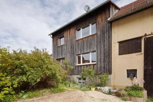 Cette ancienne maison en bois possède des fenêtres sur le côté. dans l'établissement Bikerhäusle, à Gerstetten