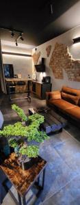 a living room with a couch and a table with plants at Luxury Vistula Old Town Apartments , hammock on the terrace, free parking! in Krakow