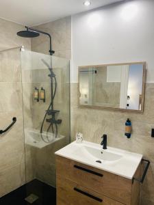 a bathroom with a sink and a shower at El Parador del César Boutique, Aparcamiento Gratis in Mérida +34 photos