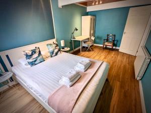 a bedroom with a large bed with blue walls at Cosy 2-bedroom house in Leith in Edinburgh