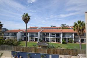 an exterior view of a resort with palm trees at Seashore Memories - Sleeps 3 in Perth