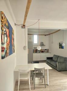a living room with a table and chairs and a couch at Mary J Apartment in Trapani