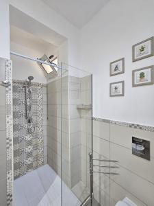 a bathroom with a shower with a glass shower stall at Mary J Apartment in Trapani