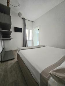 a bedroom with a large bed and a window at Mary J Apartment in Trapani