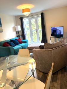 a living room with a couch and a table at Lovely 2 bedrooms apartment in Portsmouth