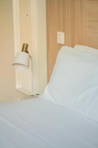 a bedroom with a bed with a lamp next to it at Select Porto Suites in Porto