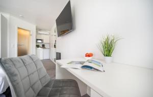 a living room with a white counter and a chair at Apartments Waterfront in Sagard