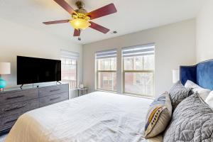 a bedroom with a ceiling fan and a television at Shimmering Slopes in Heber City