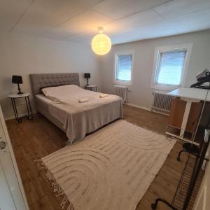 a bedroom with a bed and a rug at Villa Sandgatan in Falkenberg