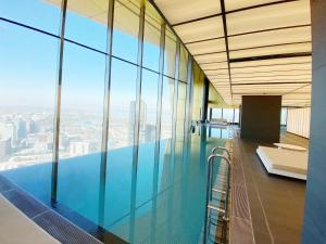 a swimming pool in a building with glass windows at Melbourne Luxury Apartment Steps away from Crown in Melbourne