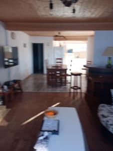 a living room with a couch and a table at Maison de vacances La Menou in Saint-Pierre-dʼOléron +11 photos