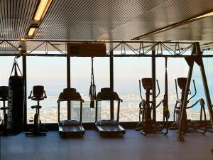 a group of treadying machines in a gym with a view at Melbourne Luxury Apartment Steps away from Crown in Melbourne