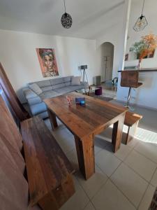 a living room with a wooden table and benches at Sofi II in Niš