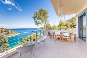 a dining room with a view of the ocean at Spacious Villa by the sea in Pefkali