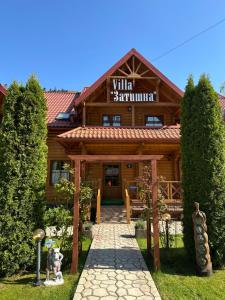 a wooden building with a sign that reads win summit at Villa "Затишна" in Mykulychyn