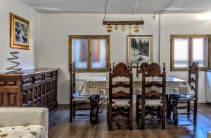 a dining room with a table and chairs at Casa Micisca - Pescasseroli Centro in Pescasseroli +8 photos