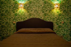 a bedroom with a bed with green wallpaper at Hotel Il Guercino in Bologna