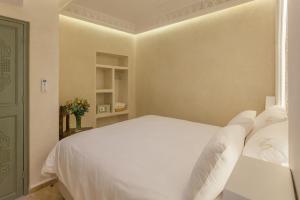 Voodi või voodid majutusasutuse Luxe Nomade Marrakech & Spa toas