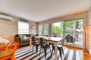 een woonkamer met een tafel en stoelen en een bank bij Lakefront Leasburg Home with Dock and Views! 