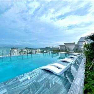 a hotel swimming pool with a view of the ocean at The Song Apartment - CONDOTEL BUNNY HOME VUNG TAU in Vung Tau