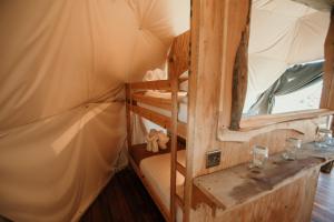 a room with bunk beds in a yurt at Dome Meadow 1 with Log Burning Tub At Tapnell Farm in Yarmouth