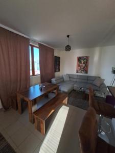 a living room with a couch and a table at Sofi II in Niš