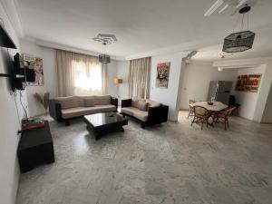 a living room with a couch and a table at appartement 14 in Chott Meriem