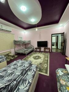 a room with two beds and a flat screen tv at شقة مؤثثة قريبه من المسجد النبوي in Sulţānah