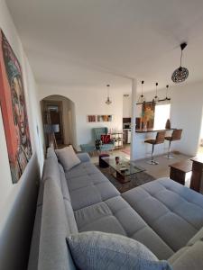 a living room with a large couch in a living room at Sofi II in Niš