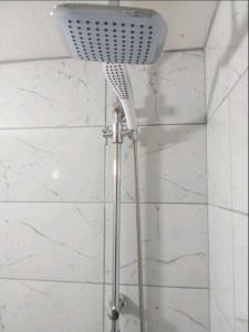 a shower with a shower head in a bathroom at Braća Kosorić in Han Pijesak