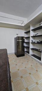 a kitchen with a large appliance in the wall at SAIBALA HOMESTAY - AC 3 BHK NEAR AlRPORT in Chennai