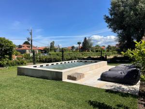 a swimming pool in the middle of a yard at Villa Cornelia, Ponte de Lima in Ponte de Lima
