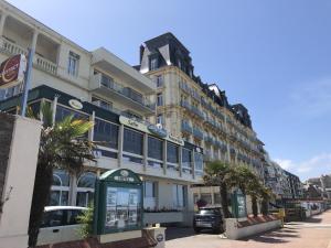 a large building with a phone booth in front of it at Hôtel Windsor Contact Hôtel in Dieppe