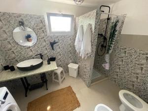 a bathroom with a sink and a toilet and a mirror at Trullo Del Salento in San Vito dei Normanni +34 photos