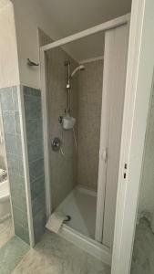 a shower with a glass door in a bathroom at Casa vacanze da Roberta a pochi km da Oristano in Simaxis