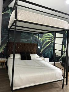 a bedroom with a bunk bed with white sheets at Bouzasol in Vigo