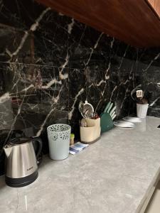 a counter top with pots and utensils on it at Kailash Villa Balangan in Jimbaran
