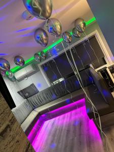 a room with purple and green lights and a dance floor at 19 Rodney Street Apartments in Liverpool